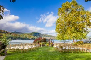 A wedding arch and rows of chairs are set up for a wedding on a sunny day at Lake Morey Resort