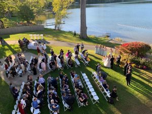 An overhead shot of guests sat in rows during a lakeside wedding on a sunny afternoon at Lake Morey Resort, one of the best wedding venues in Vermont.